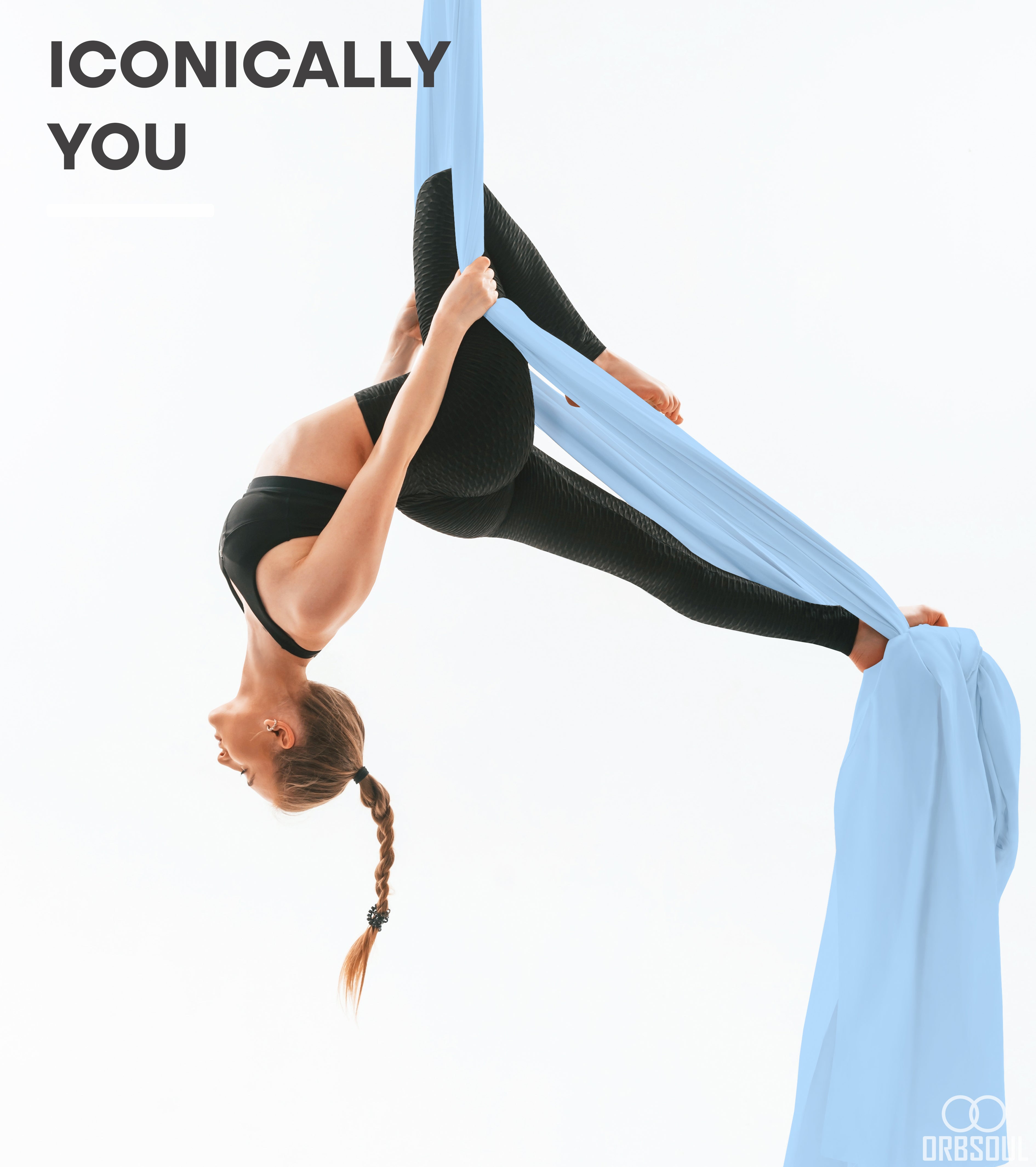 Woman doing aerial arts pose with aerial silks with text that says iconically you