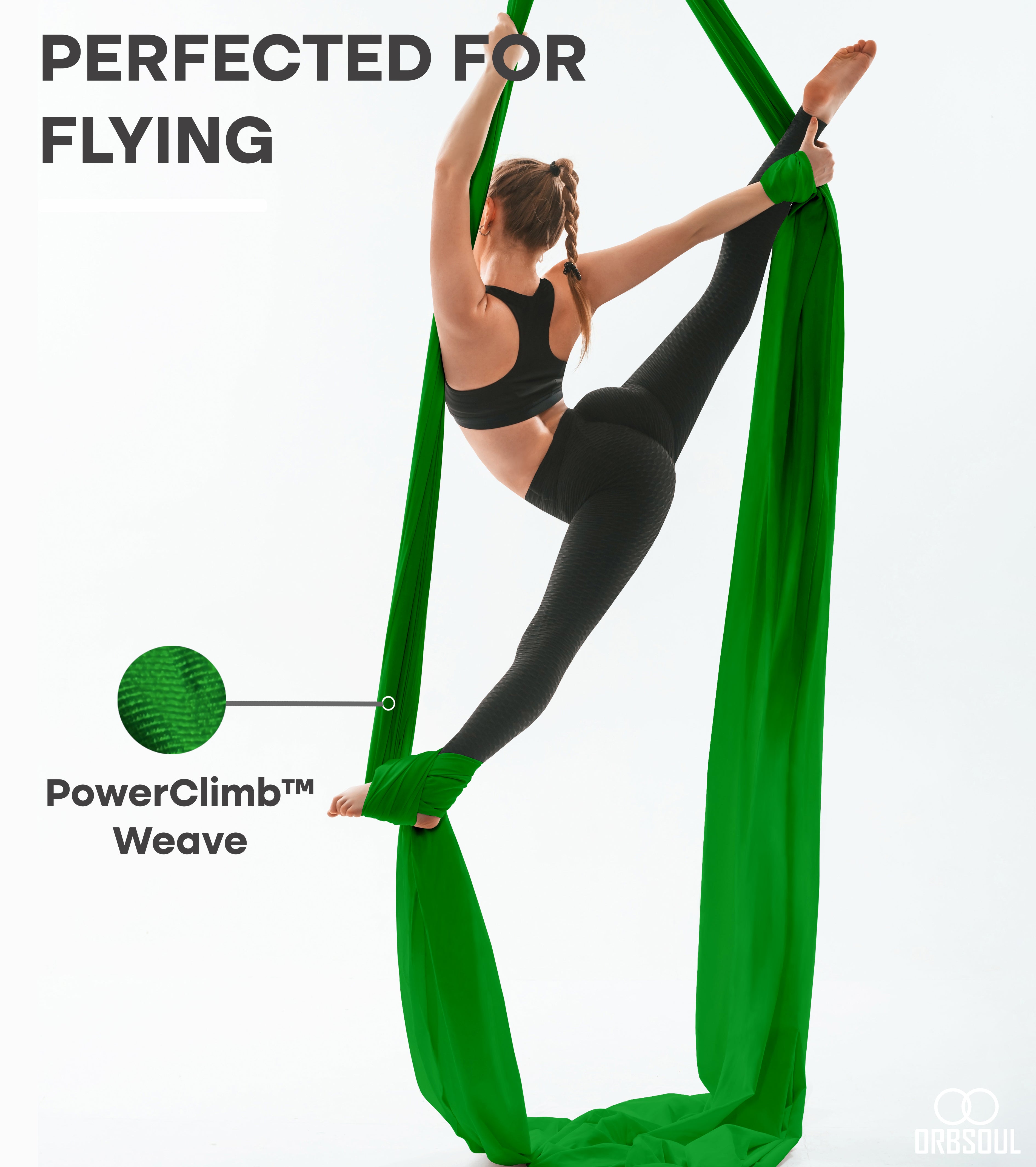 woman performing aerial art using aerial silks emerald green