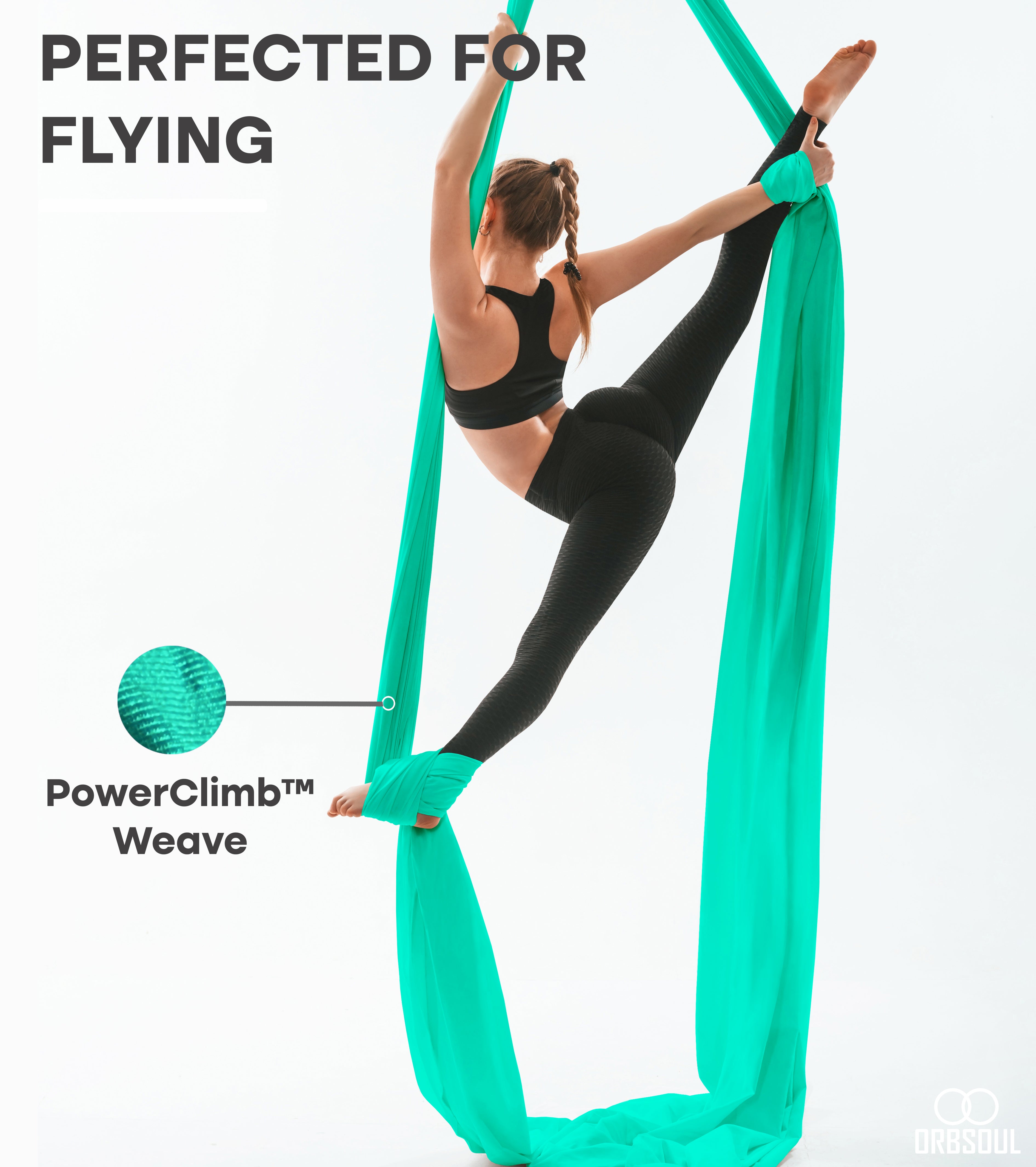 woman doing aerial silks using turquoise aerial silks