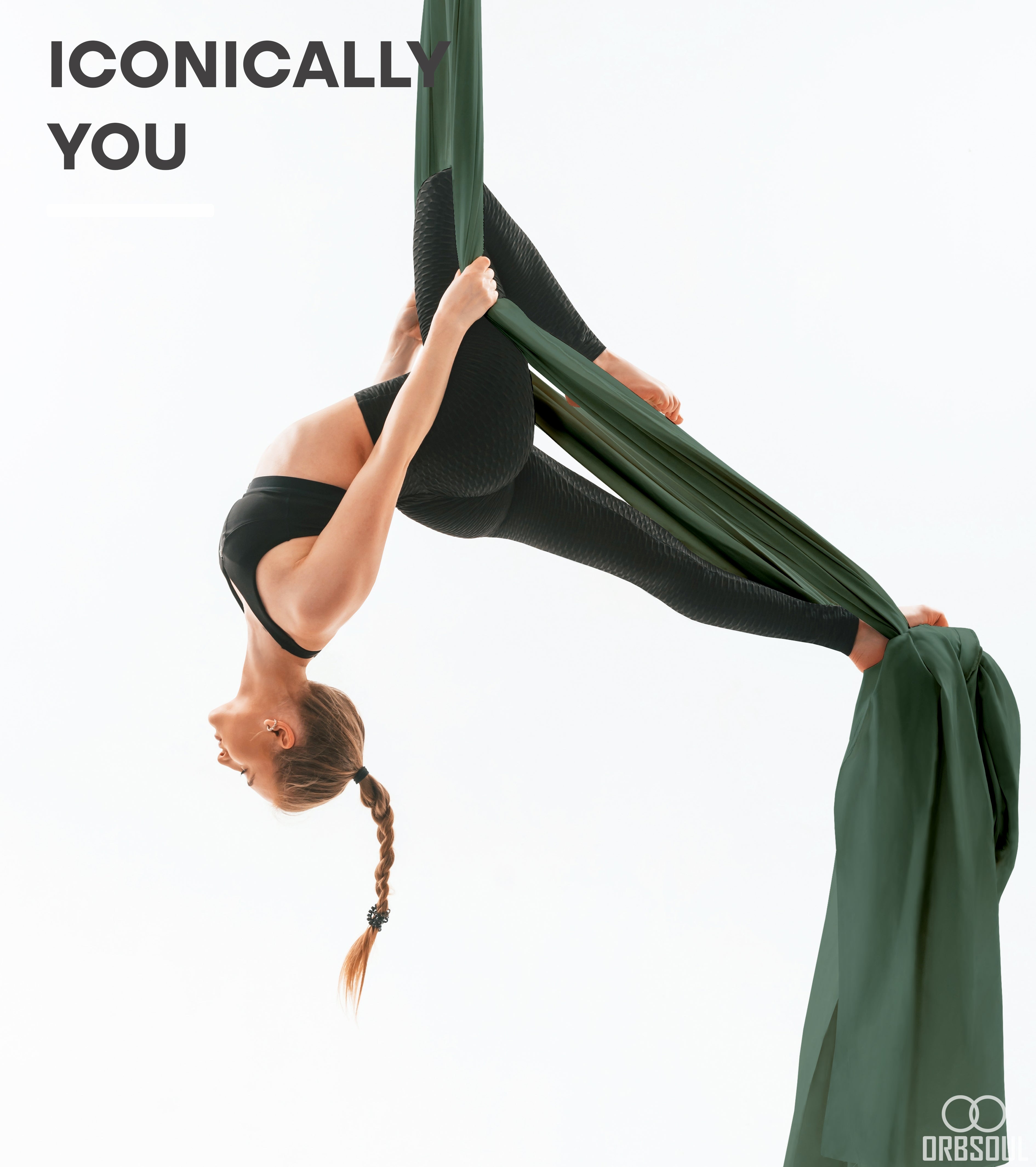 Woman doing aerial arts pose with aerial silks with text that says iconically you